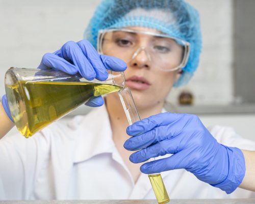female-researcher-with-safety-glasses-hair-net-doing-science-experiments